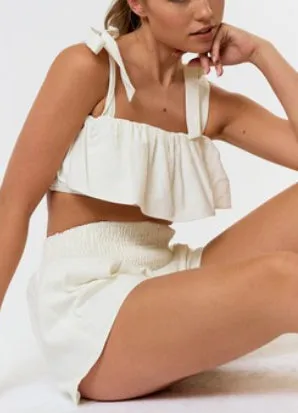 White ruffle linen shorts with ruched waist